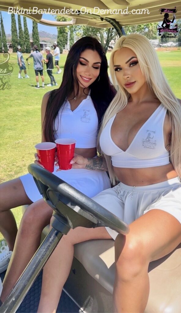 two women in a Golf cart