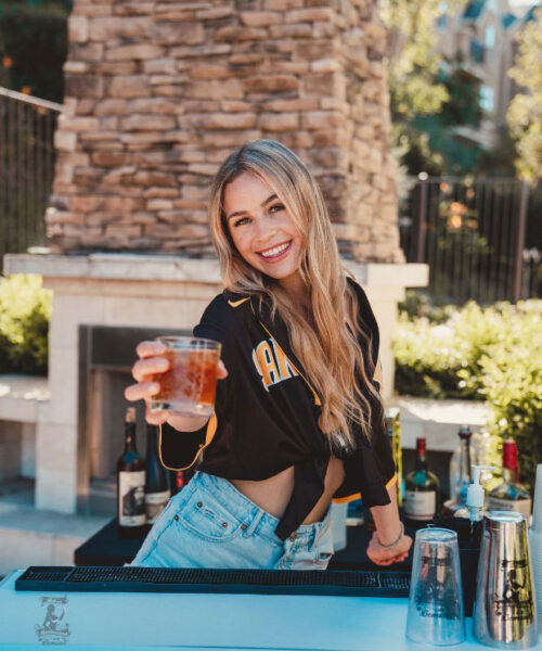 A woman holding a drink in her hand.